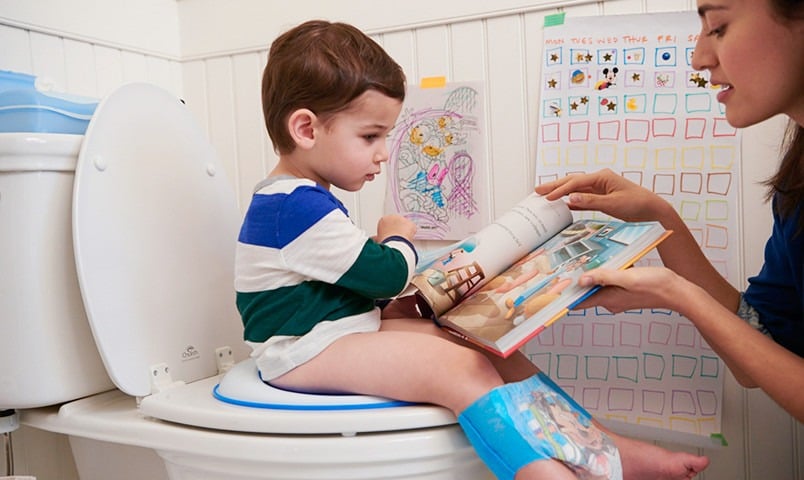 Child on the potty reading a children's book