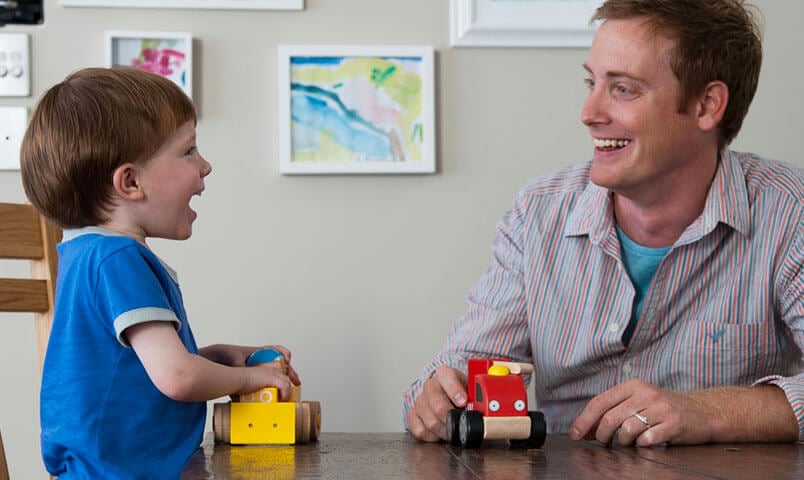 Child playing with toys with his father