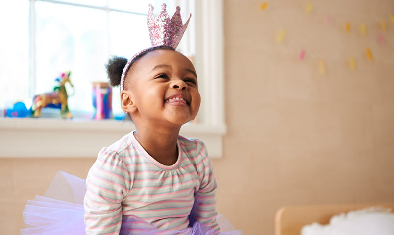 Little girl smiling with a potty crown