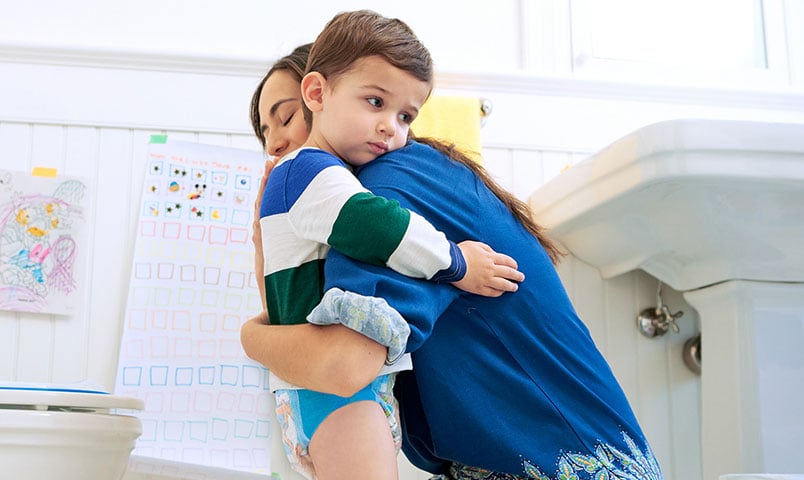 Child and mother hugging in bathroom