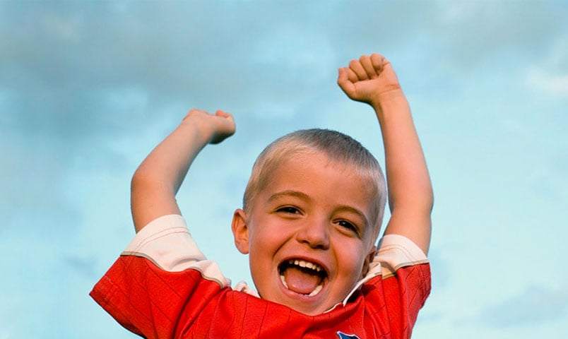 Toddler boy happily cheering