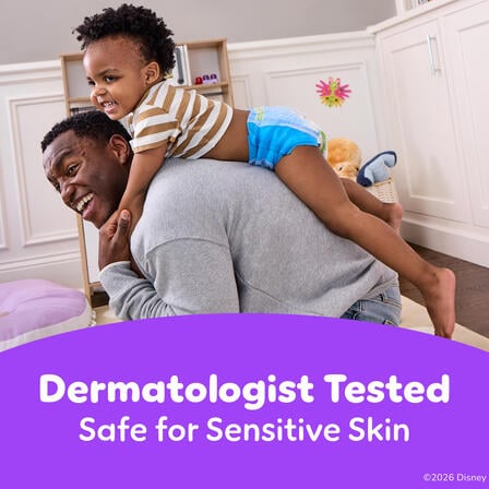 Child rides on an adult’s back indoors wearing Pull-Ups, with text “Dermatologist Tested – Safe for Sensitive Skin.”