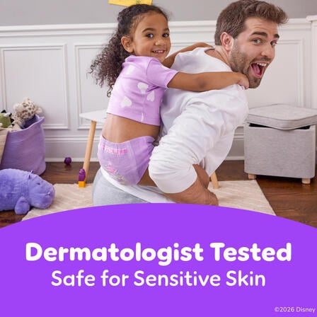 Child rides on an adult’s back indoors wearing Pull-Ups, with text “Dermatologist Tested – Safe for Sensitive Skin.”