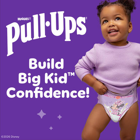 Toddler in Pull-Ups training underwear on a purple background beside “Huggies Pull-Ups” and “Build Big Kid Confidence!”